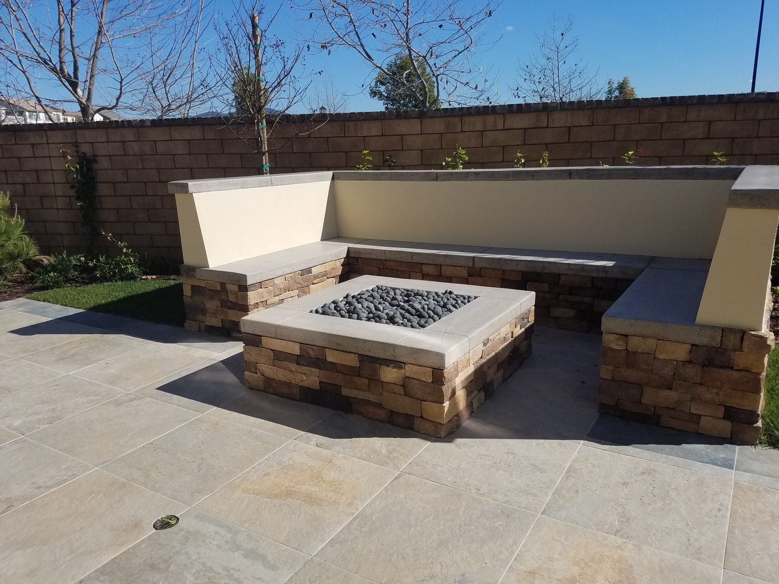 Chan Residence — Stacked-stone gas fire pit and bench seating