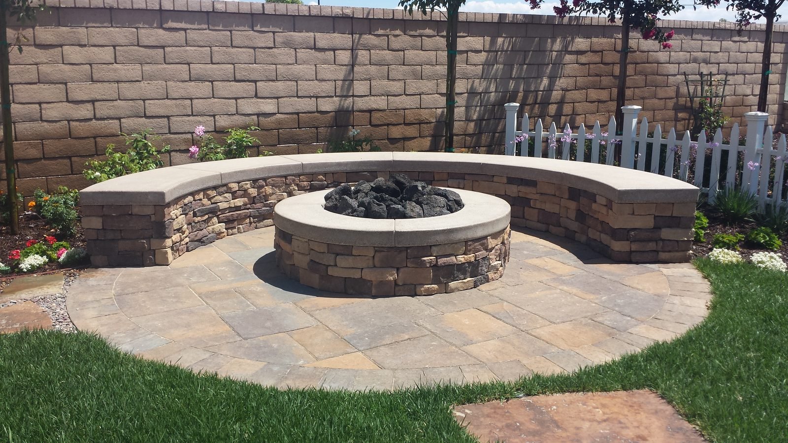 Eftekhari Residence — Stone fire pit with a curved seat wall
