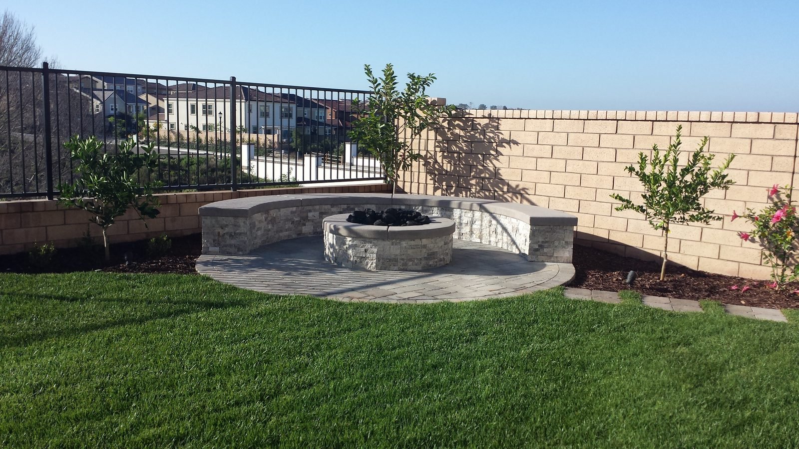 Krishran Residence — Stone fire pit and seat wall with the view