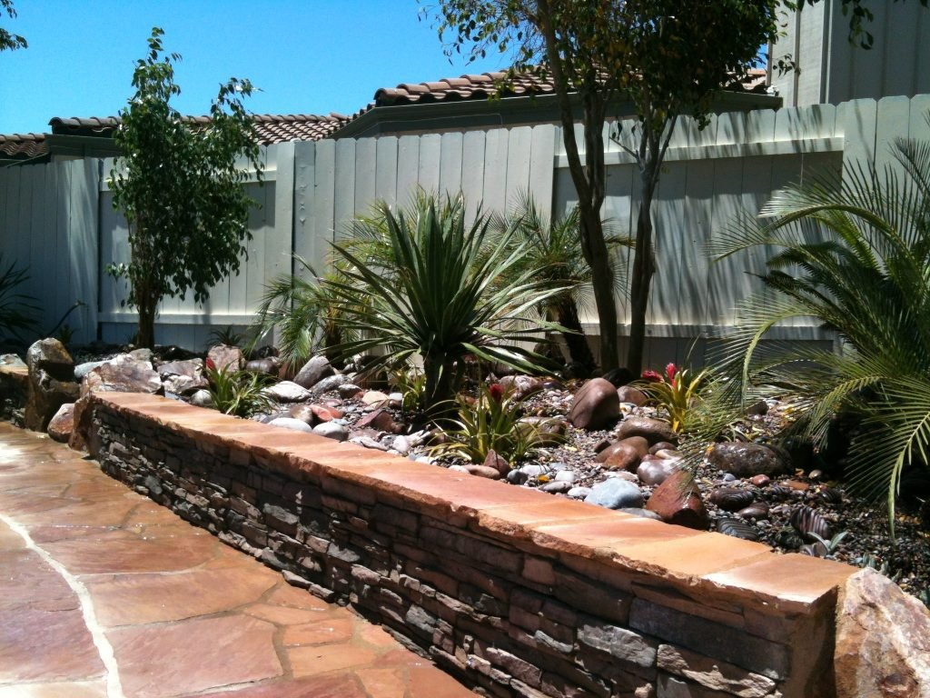Lottes Residence — Raised stone planter wall with palms