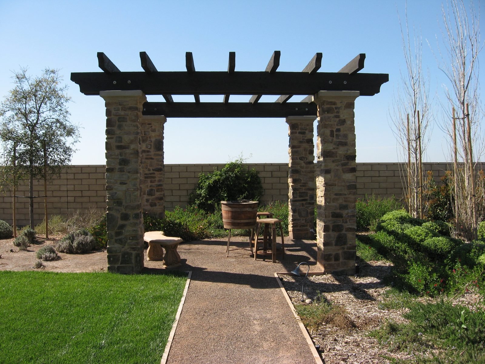 Modello Residence — Stone-column pergola over the garden path