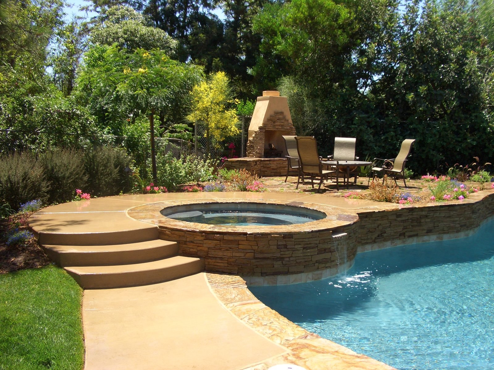 Peterson Residence — Freeform pool and spa with the stone fireplace beyond