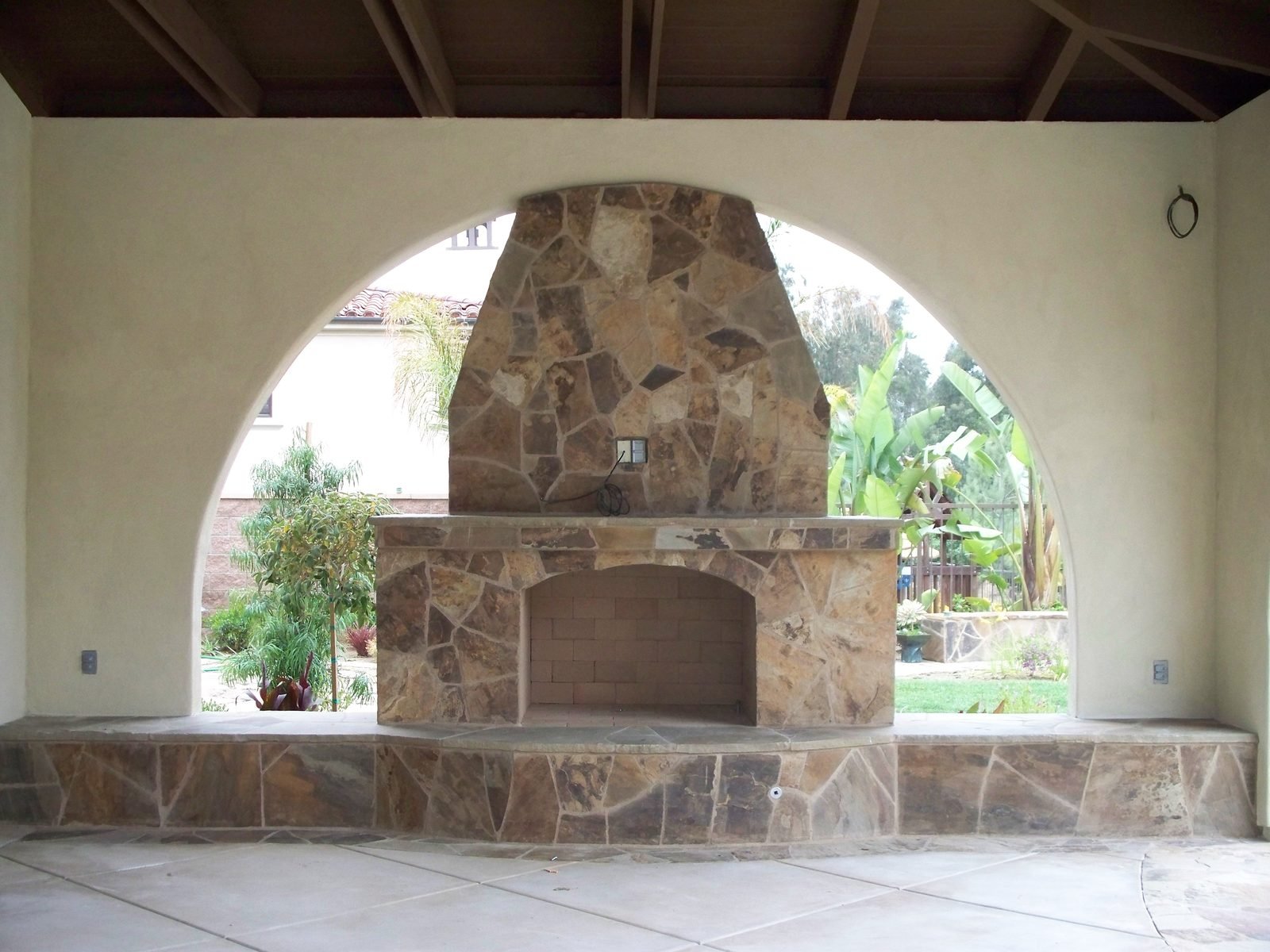 Spenst Residence — Stone outdoor fireplace under the loggia