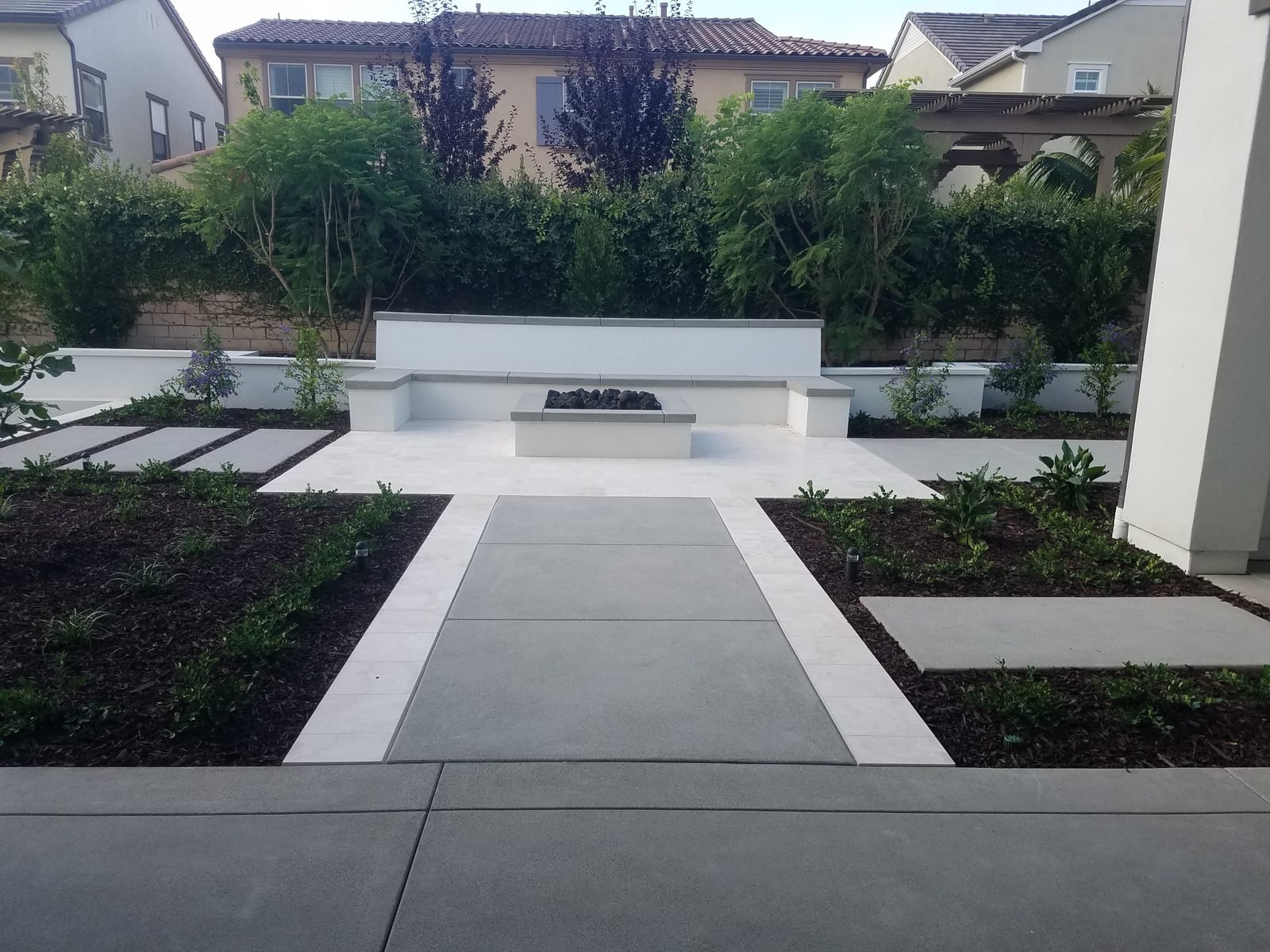 Xu Residence — Linear pavers and planters with a fire feature