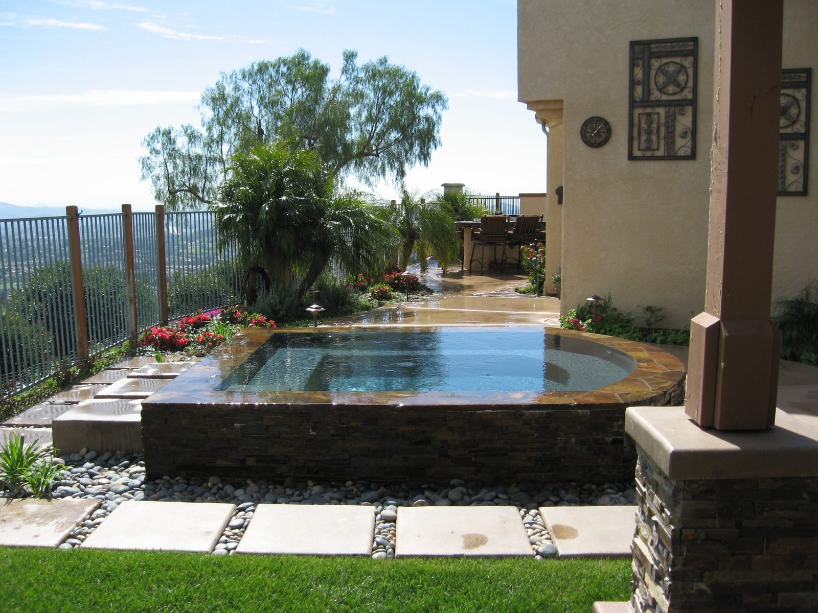Infinity-edge spa built into a canyon-view lot in San Diego County